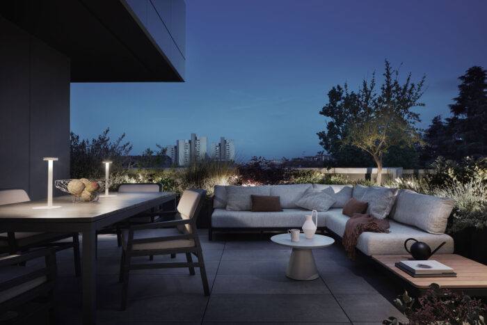 modern penthouse terrace with outdoor furniture and plants during night